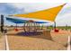 Vibrant playground with colorful play structures, shade canopies, and soft ground cover for safe play at 10127 E Tillman Ave, Mesa, AZ 85212