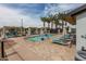 Inviting neighborhood splash pool with covered seating, lounge chairs, and lush palm trees at 10127 E Tillman Ave, Mesa, AZ 85212