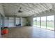 Bright yoga studio with wood floors, large windows, and storage shelves for equipment at 10127 E Tillman Ave, Mesa, AZ 85212