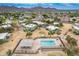 Aerial view of community featuring pool, lush landscaping, covered parking, and mountain views under a clear, blue sky at 10215 N 8Th St # B, Phoenix, AZ 85020