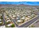 Expansive aerial view showcasing the community's layout, lush landscaping, and mountain views under a clear, blue sky at 10215 N 8Th St # B, Phoenix, AZ 85020