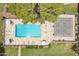 Aerial view of sparkling pool with lounge chairs, umbrellas, and well-kept landscaping under a clear, blue sky at 10215 N 8Th St # B, Phoenix, AZ 85020
