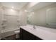 Bathroom with wood-look floors, dark vanity, white counter, and tub with white tile surround at 1074 W West Virginia Ave, Florence, AZ 85132