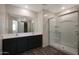 Modern bathroom with double sink vanity, large mirror, and glass-enclosed shower at 1074 W West Virginia Ave, Florence, AZ 85132