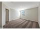 Bright bedroom with plush carpeting and a window with blinds letting in natural light at 1074 W West Virginia Ave, Florence, AZ 85132
