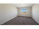 Neutral bedroom featuring carpet floors and view from the window showing the outside landscape at 1074 W West Virginia Ave, Florence, AZ 85132