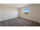 Bedroom featuring neutral tones, carpet floors, and view from the window showing neighboring roof at 1074 W West Virginia Ave, Florence, AZ 85132