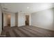 Spacious bedroom featuring neutral tones, carpet flooring, and an open doorway to another room at 1074 W West Virginia Ave, Florence, AZ 85132