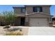 Charming two-story home featuring a two-car garage and desert landscaping at 1074 W West Virginia Ave, Florence, AZ 85132