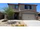 Charming two-story home featuring a two-car garage and desert landscaping at 1074 W West Virginia Ave, Florence, AZ 85132