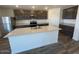 Modern kitchen features granite countertops, stainless steel appliances, and island at 1074 W West Virginia Ave, Florence, AZ 85132