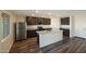 Kitchen with stainless steel appliances, dark wood cabinets, granite countertops, and a center island with sink at 1074 W West Virginia Ave, Florence, AZ 85132