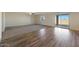 Spacious living room featuring a combination of plush carpeting and wood-look flooring, enhanced by natural light at 1074 W West Virginia Ave, Florence, AZ 85132