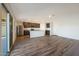 Spacious living area with access to the kitchen, sliding glass doors, plush carpet, and modern wood flooring at 1074 W West Virginia Ave, Florence, AZ 85132