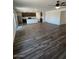 Open concept living space featuring luxury vinyl plank floors and modern kitchen at 1074 W West Virginia Ave, Florence, AZ 85132