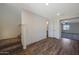 A staircase leads to a living room area featuring modern wood-look flooring and a view of the carpeted space at 1074 W West Virginia Ave, Florence, AZ 85132