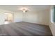 Cozy living room with plush carpeting, a ceiling fan, and access to the foyer, promoting a welcoming atmosphere at 1074 W West Virginia Ave, Florence, AZ 85132