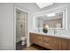Bathroom with walk-in shower, dual vanity, illuminated mirror, and modern fixtures at 11079 N 110Th Pl, Scottsdale, AZ 85259