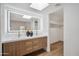 Bathroom features a dual sink vanity, an illuminated mirror, and a walk-in closet at 11079 N 110Th Pl, Scottsdale, AZ 85259