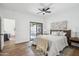 This bright bedroom features a ceiling fan and a sliding glass door to the back yard at 11079 N 110Th Pl, Scottsdale, AZ 85259