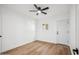 Bright bedroom features wood floors, ceiling fan, window, and a white door at 11079 N 110Th Pl, Scottsdale, AZ 85259