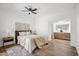 This bright bedroom features an ensuite bathroom, ceiling fan and modern decor at 11079 N 110Th Pl, Scottsdale, AZ 85259