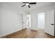 This empty bedroom features wood look floors and multiple access doors at 11079 N 110Th Pl, Scottsdale, AZ 85259