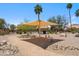 Community area offers shade, seating, desert landscaping, and rock decor at 11079 N 110Th Pl, Scottsdale, AZ 85259