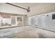 Large, clean garage with multiple entry doors, windows, and overhead lighting at 11079 N 110Th Pl, Scottsdale, AZ 85259