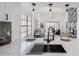 Open kitchen with view into the living area, modern lighting, and stainless steel sink at 11079 N 110Th Pl, Scottsdale, AZ 85259