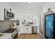 Modern kitchen with stainless steel appliances, white cabinetry, and backsplash at 11079 N 110Th Pl, Scottsdale, AZ 85259