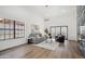 Bright living room features a fireplace, modern lighting, and a sliding glass door that lets in plenty of light at 11079 N 110Th Pl, Scottsdale, AZ 85259