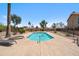 Community pool area surrounded by deck chairs, palm trees and desert landscaping at 11079 N 110Th Pl, Scottsdale, AZ 85259