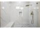 The shower is tiled in white marble with a built-in bench, a niche, and gold fixtures at 11079 N 110Th Pl, Scottsdale, AZ 85259