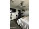 Neutral bedroom with a ceiling fan, closet, and dresser with TV setup at 11250 N 33Rd Ave, Phoenix, AZ 85029