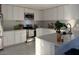 Bright kitchen featuring white cabinets, stainless steel appliances, and a spacious countertop at 11250 N 33Rd Ave, Phoenix, AZ 85029