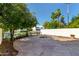 An outdoor patio features stone flooring, a fire pit, and overlooks the serene canal at 1134 E Driftwood Dr, Tempe, AZ 85283