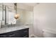 Bathroom featuring modern vanity with marble countertop and decorative light fixture at 1134 E Driftwood Dr, Tempe, AZ 85283