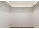 Empty white walk-in closet with shelving ready for customization and storage at 1134 E Driftwood Dr, Tempe, AZ 85283