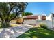 Home exterior featuring a concrete driveway, two garages, and manicured lawn at 1134 E Driftwood Dr, Tempe, AZ 85283