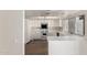 Bright kitchen featuring all-white cabinetry, countertops, and modern appliances at 1134 E Driftwood Dr, Tempe, AZ 85283