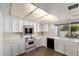 Bright kitchen featuring all-white cabinetry, countertops, and modern appliances at 1134 E Driftwood Dr, Tempe, AZ 85283