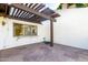 Covered patio with stone flooring and an exterior window provides a cozy outdoor living space at 1134 E Driftwood Dr, Tempe, AZ 85283