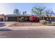 Charming single-story home boasts solar panels, a lush bougainvillea, and a two-car garage at 116 E Helena Dr, Phoenix, AZ 85022
