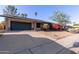 Charming single-story home boasts solar panels, a lush bougainvillea, and a two-car garage at 116 E Helena Dr, Phoenix, AZ 85022