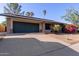 Charming single-story home boasts solar panels, a lush bougainvillea, and a two-car garage at 116 E Helena Dr, Phoenix, AZ 85022