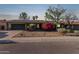 Charming single-story home boasts solar panels, a lush bougainvillea, and a two-car garage at 116 E Helena Dr, Phoenix, AZ 85022