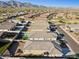 Expansive aerial view of a neighborhood with houses, backyard pools, and desert landscaping against a mountain backdrop at 12176 E Chevelon Trl, Gold Canyon, AZ 85118