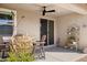 Comfortable back patio with outdoor seating, a ceiling fan, and decorative elements, ideal for relaxation and dining at 12176 E Chevelon Trl, Gold Canyon, AZ 85118