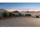 Spacious backyard featuring desert landscaping, a block fence for privacy, and mountain views at 12176 E Chevelon Trl, Gold Canyon, AZ 85118